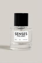 SENSES THE LABEL Eau de Parfum Flakon vor warmem Greige-Hintergrund