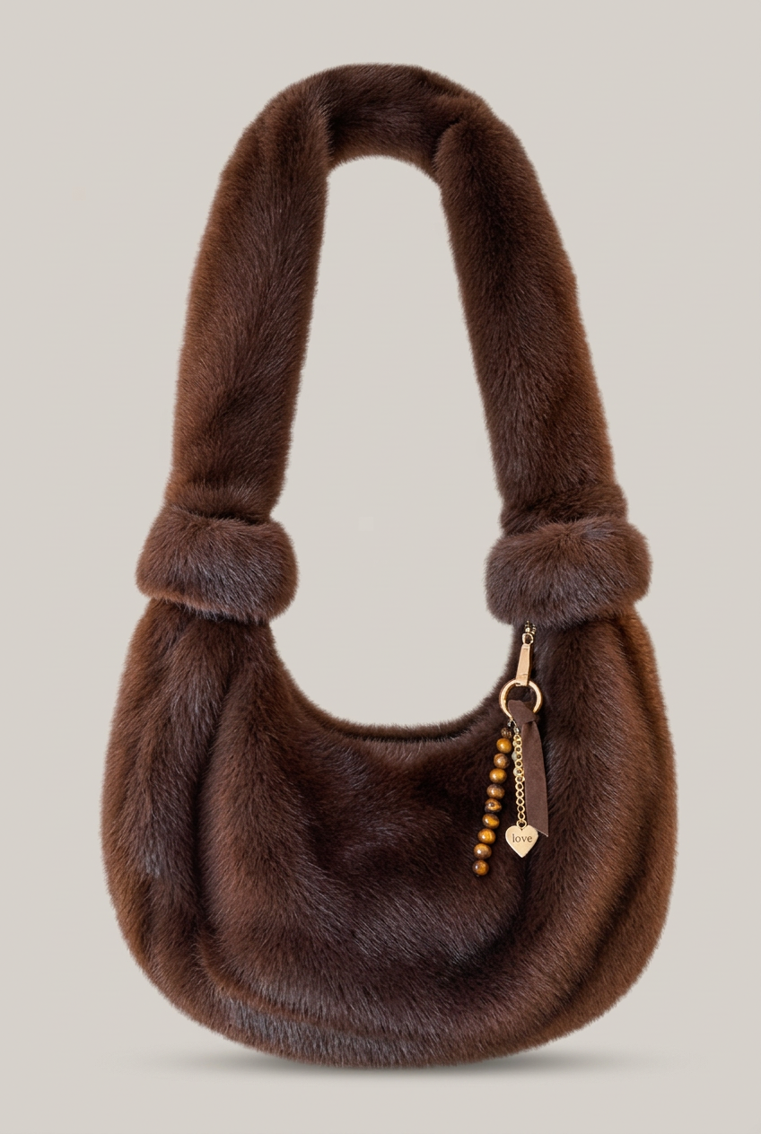 Braune MosMosh CIA Faux-Fur-Tasche vor warmem hellem Greige-Hintergrund